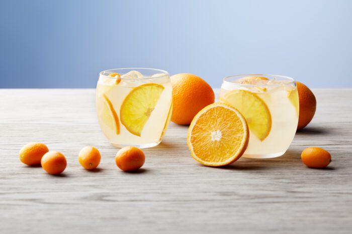 glasses-of-delicious-lemonade-with-ripe-oranges-on-2022-01-19-00-04-13-utc